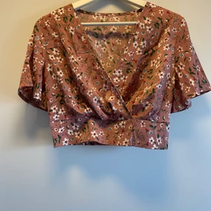 Blommig omlott top - Aldrig använd, tunn i tyget. Fint skick.