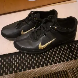Äkta Nike sport skor i svart i guld detaljerat. Knappast använda,allt för många skor som jag inte hinner att använda 