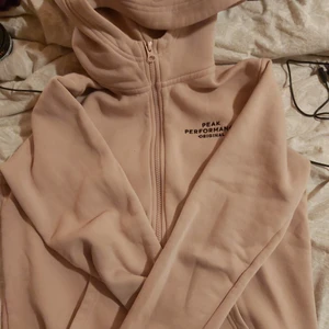 Peak performance ziphoodie - Storlek 160 barnstorlek men passar mig som M i dam. Bra passform med hög krage vid halsen. Flossad och superskön, ljusrosa, använd aktivt under en månad bara. Köpt för 1200