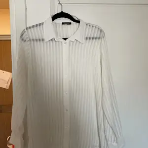 En vit genomskinlig skjorta använd ett fåtal gånger. 