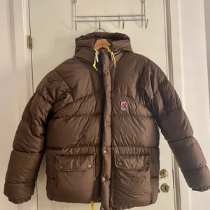 Brun Fjällräven jacka  - På grund av oseriösa köpare lägger jag upp den igen 🥰Köpte den här jackan från en plick-användare men den passade dessvärre inte mig så jag säljer den vidare. Det står att den är xs men skulle säga att den mer lutar mot en M/L. Jättefin kvalité dock är självaste ”hängaren” av (se bild 2) men kan nog gå att sy fast. 