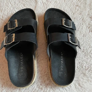 Sandaler - Svarta sandaler med gulddetaljer. Storle 36. Köpta i Spanien på primark. Undersidan är lite sliten men anars i bra skick. Pris går att diskutera. 
