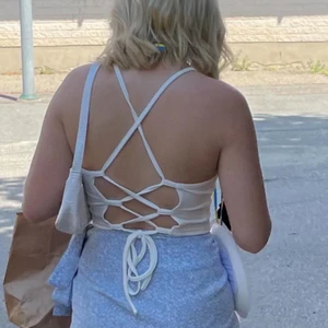 Vit topp med knytning 🤍 - Säljer denna fina toppen från shein 🤍 nyskick! Passar xxs-s då man justerar i ryggen ☺️