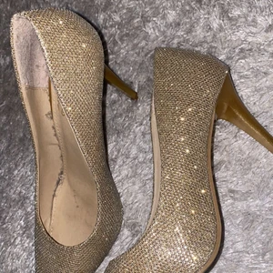 Bailaiqi - Högklak skor Stolrlek 38 guld färg använd en gång  passar till fest skonat  höjd 9cm köpt fran Nelly 