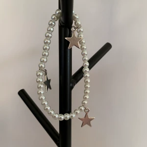 Vitt pärlarmband med silvriga stjärnberlocker - Vitt pärlarmband med silvriga stjärnberlocker⭐️ Pris: 39kr/st. Fraktkostnad på 12kr tillkommer.