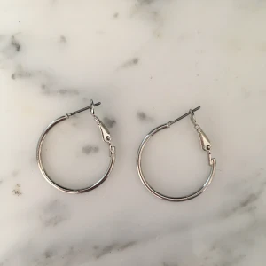 Silvriga örhängen  - Ett par helt oanvända runda örhängen. Dessa säljs pågrund av att jag har flera andra!🌟🌟