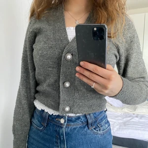 Kofta med pärlor🤍 - Jättefin grå kofta med pärlknappar. Lång ärm. Stickad. Passar med blåa jeans, svarta jeans eller kjol. Den är superbekväm!😊 Storlek XS men passar perfekt på S!💗 (Jag är personligen S) Material: ylle, akryl och polyester.