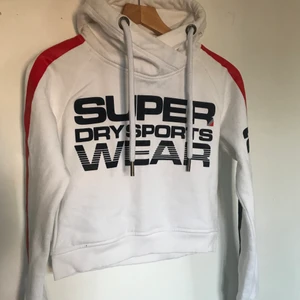 SuperDry hoodie  - Super cool och sportig hoodie från SuperDry. Den är använd men i gott skick! Tyget vid handlederna är lite missfärgat på insidan!