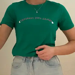 En skön mörkgrön t-shirt i storlek M. Rosa text på franska och vita hjärtan. Köpt i England och har haft den i några år men den är i bra skick. 100% bomull. Säljer pga att den inte används. Kan mötas i Umeå eller skicka om köpare står för frakt. Spårbar: 66kr, icke-spårbar: 30kr