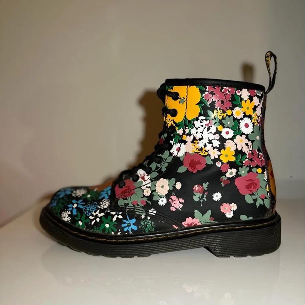 Dessa Dr.Martens skor är använda men i ny skick. Blommig design med 2 olika sidor på varje sko (Bilder finns på båda sidor). Tål vatten och passar bra till vintern. Passar bäst med svarta jeans. Storlek: EU 36/ 2 UK/ 3 US. Skor.