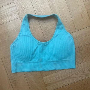 NVGTN Sports Bra - Good condition. Lovely turquoise colour, pretty for the summer. Beautiful neckline. It has inserts to put removable pads. A good price for this brand.