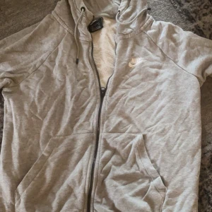 Grå Nike kofta - Från Intersport . OBS! Dragkedjan har fastnat som den är på bilden 