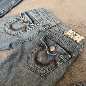 True Religion jeans - Säljer dessa super snygga jeans från true religion. Storlek 23 men passar folk som är ca 159-164 ish❣️ Bootcut men kan upplevas som lite mer straight när man har dom på beroende på hur stora vader man har💕 Lowwaist. Super fint skick och inga defekter.