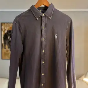 Ralph Lauren-skjortan är en klassisk och sofistikerad herrskjorta tillverkad av högkvalitativt material, med en tidlös passform och stil. Den kännetecknas av sitt eleganta design, fina detaljer och ikoniska broderade logotyp på bröstet.