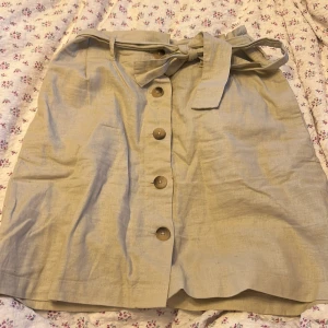 Linnekjol - Beige linnekjol med knappar och knytning