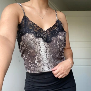 Ormmönstrad linne  - Jätte snygg linne med spets på toppen. Jätte luftig och skön att bära. Knappt använd. 