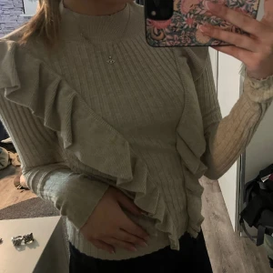 Volang tröja  - Stickad volang tröja, i storlek s. Använd några gånger. Men i väldigt bra skick. 