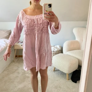 Ljus rosa sommarklänning - Super söt kort rosa sommarklänning med detaljer fram och en snygg halsringning