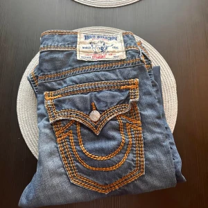 True religion jeans - Blåa trueys med orange stitch i modellen ”straight”. baggy fit, väldigt bra skick  Kom dm för frågor och funderingar
