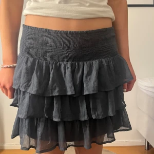 JÄTTE FIN KJOL!! - Säljer denna jättefina mörkblåa volang kjolen från vero Moda. Den säljs inte längre!! Är därför en gammal modell!! 