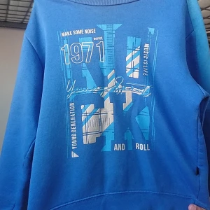 Blue Sweatshirt - It is a little used now but is for boys of age 8 or 9. It is just for boys. It is a foreign country sweatshirt. Prices can be lower if interested