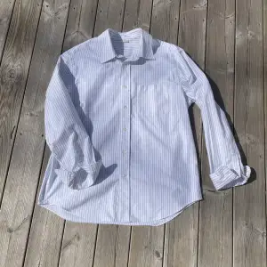 en grå randig skjorta från arket som aldrig är använd eller tvättad