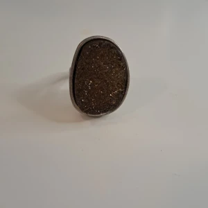 Ring - This is an elegant ring that i bought and was big on my finger. I tried to put nail polish inside to make it smaller but it didnt work. It is still new though. 