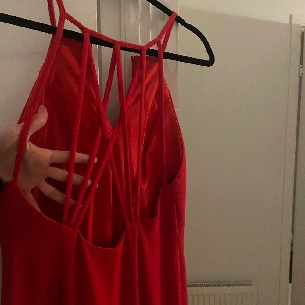 Röd balklänning med rygdetaljer.  Använt den 1 gång.  Frakt ingår inte. . Klänningar.