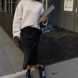 Svart satinkjol med slits - Svart satinkjol me slits från Weekday Storlek 34 men stretchig så passar även 36 Resårband i midjan  Använd några gånger så ser helt ny ut Inga defekter  Skulle säga det är midilängd 💗