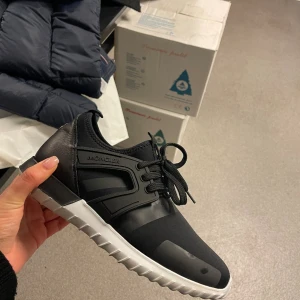 Moncler sneakers  - Säljer mina svarta moncler sneakers, perfekt skick använda ca 2-3 gånger. Super fina men säljer då de inte kommer till användning. Logga på baksidan av skon