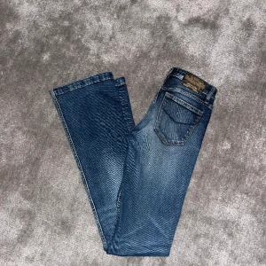 Lågmidjade bootcutjeans - Säljer dessa superfina lågmidjade bootcut jeans från crocker. Såååå fina men tyvärr lite lite små på mig. Superfint skick, köpta här på Plick. Innerbenslängd 83, midjemått 33 rakt över men strechiga. Sry för dålig bildkvalité, hör av er vid frågor mm