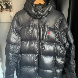 Ralph Lauren Puffer Jacka - Ralph lauren puffer jacka Glänsande mörk blå färg (ser ut som svart) Väldigt varm Haft i 1-2 år Nypris: runt 4500