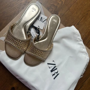 Guldiga sandaler  - Säljer dessa aaas snygga sandaler/tofflor från zara då de var för små för mig! HELT oanvända och prislapp kvar, påse tillkommer💕💕