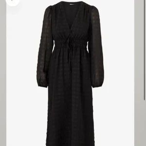 Svart långklänning med knytning - Säljer en elegant svart långklänning med knytning i midjan. Klänningen har en v-ringad hals och långa ärmar. Perfekt för festliga tillfällen eller en kväll ute. Materialet är lätt och bekvämt, vilket gör den idealisk för både vår och höst.