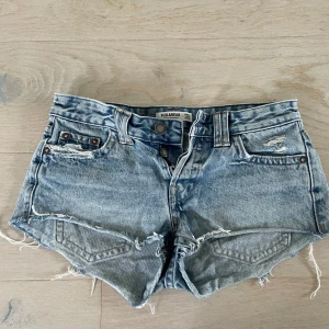 Jeansshorts - Säljer dessa jättefina lågmidjade jeansshorts eftersom de blivit för små för mig. De är i fint skick och endast använda ett fåtal gånger. Kommer från djur och rökfritt hem. Frakt betalas av köparen. Midjemåttet är 74cm (lågmidjade byxor)