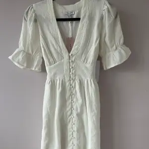 Jättefin vit klänning med knytdetalj baktill. Nyskick, endast testad 2 gånger och alla lappar är kvar:) Köpt för 699kr på bubbleroom.