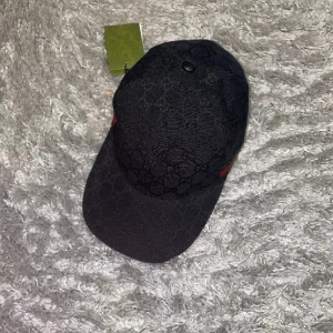 Svart Gucci keps  - Säljer min svarta Gucci keps, har använt den ett par gånger och har ingen användning av den längre. Skick 9/10, dust bag och tags ingår vid andra frågor eller fler bilder skriv Dm. Pris kan diskuteras