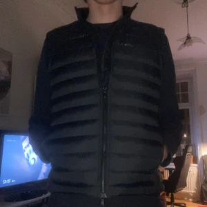 J.LINDEBERG - Säljer nu denna stilrena J. LINDEBERG västen eftersom den är för kort för mig. Västen är helt oanvänd och jag har även kvitto och prislapp kvar på västen. Västen är size L men funkar på M också. Västen är även slutsåld i affär. Skriv om ni har frågor