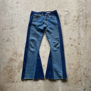 Striped Flare Jeans - Crafted from handpicked vintage denim, this piece features a flared cut and distressed details for a stylish, worn-in look with stripes