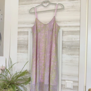 Rosa och grön klänning från Adidas - Rosa och grön klänning från Adidas med smala axelband, oanvänd. Ormskinnsmönster, snake skin pattern, ljusrosa underklänning och mönstrat mesh. 