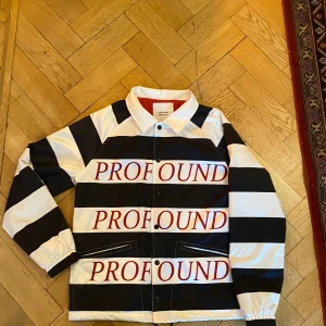 Profound aesthetic, satin effect coach jacket. - Good condition (barely worn), regular fit. Size small. Satin effect, striped white and black with red logos.
