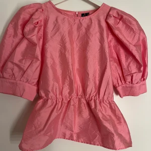 Festtopp - Fin rosa skimrig topp med puffärm och volang från Vero Moda! Använd en gång.💕