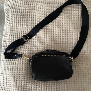 Svart liten axelremsväska - Väldigt användbar väska som passar till allt!
