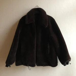 Stand studio Jacka - En reversibel jacka från Stand Studio i fluffigt material på ena hållet och slätt material på andra. Den har en liten reva som bara syns om man har den sidan utåt