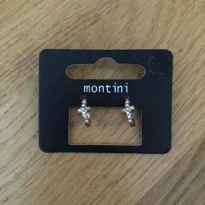 Kors örhängen  - INTE ANVÄND. Kors örhängen från Ur&Penn, (märket Montini). Guldiga med vita stenar ”diamanter”. 