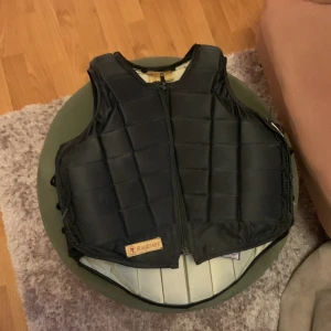 Racesafe väst barn - Känns mer som M/L men den är iaf en äldre modelle av racesafe och är i bra skick. Enligt mig är den ganska liten i storleken. Västen är svart och beige på insidan❤️