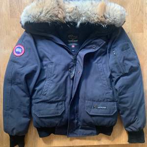 Hej!  Tänkte sälja min Canada Goose Chilliwack. Den är i allmänt bra skick!  Vad som ingår: •Fin päls •Slitna muddar (se bild 4) •Fyra Fickor •Nypris 10 000kr  Skriv gärna fler frågor vid intresse!