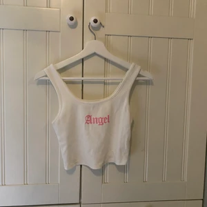 Söt topp - Fin ribbad croppad topp men rosa tryck framtill. Sparsamt använd. Skriv vid intresse/fler bilder. Köpare står för frakt