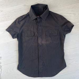 Original Diesel shirt with nice semi see-through organic print. In good condition, fabric shows slight decolorisation as pictured.