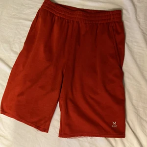 Röda basketshorts  - Tunna och sköna att sporta i. Blir inte lika svettigt. Sitter bra med snöret. Stora fickor och knappt använda. 